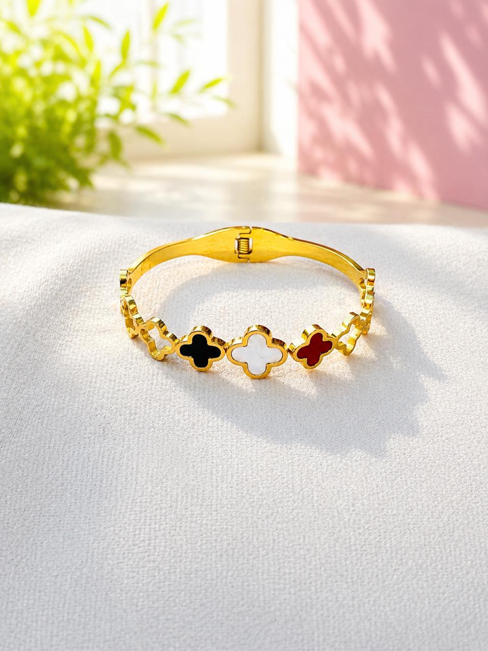 Sentiara Clover Bangle features alternating black and white stations crafted from anti-tarnish stainless steel