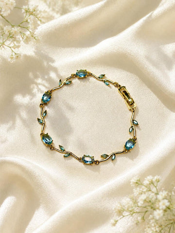 vine bracelet features blue stones and green leaf accent