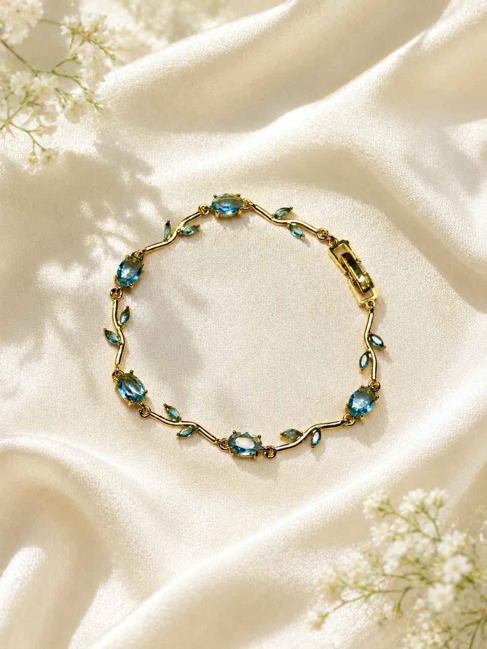 vine bracelet features blue stones and green leaf accent